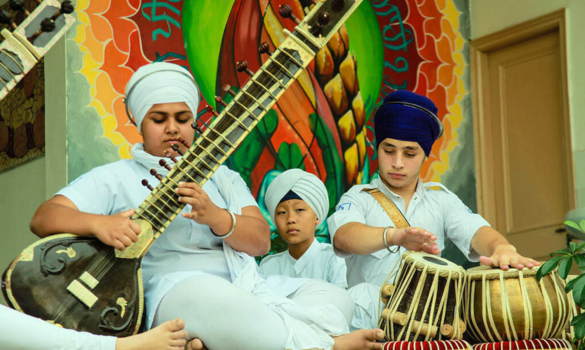 children playing kirtan
