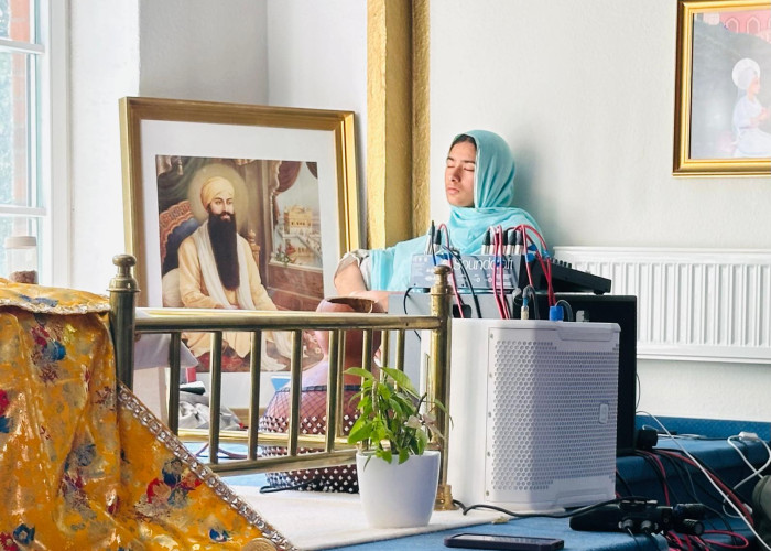 2026 German Smagam - woman in gurdwara with picture of Guru Ram Das